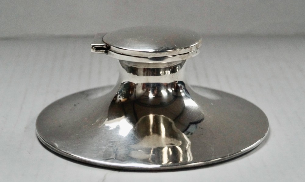 A solid sterling silver capstan inkwell with a circular flared base and an open hinged lid, displaying Birmingham hallmarks. View II