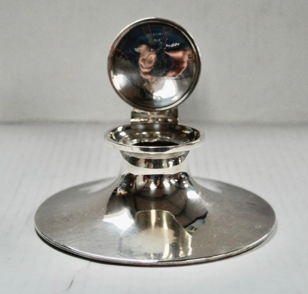 A solid sterling silver capstan inkwell with a circular flared base and an open hinged lid, displaying Birmingham hallmarks. View V