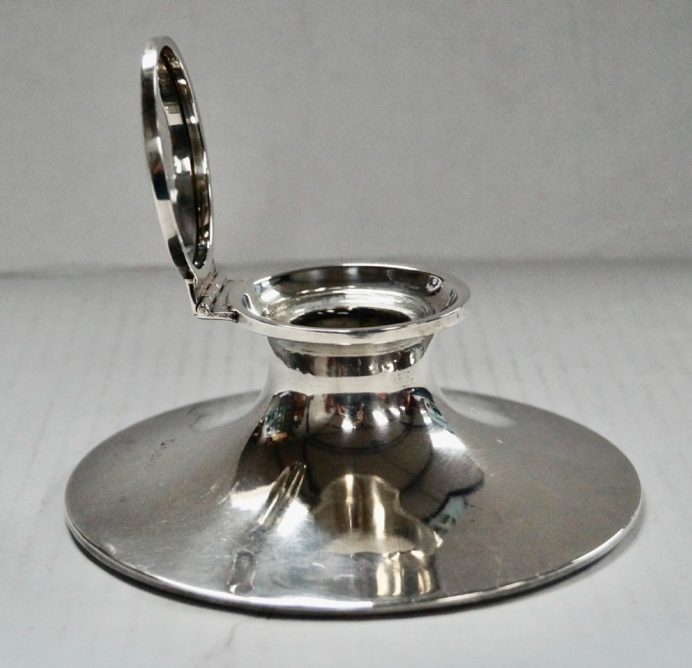 A solid sterling silver capstan inkwell with a circular flared base and an open hinged lid, displaying Birmingham hallmarks. View VI