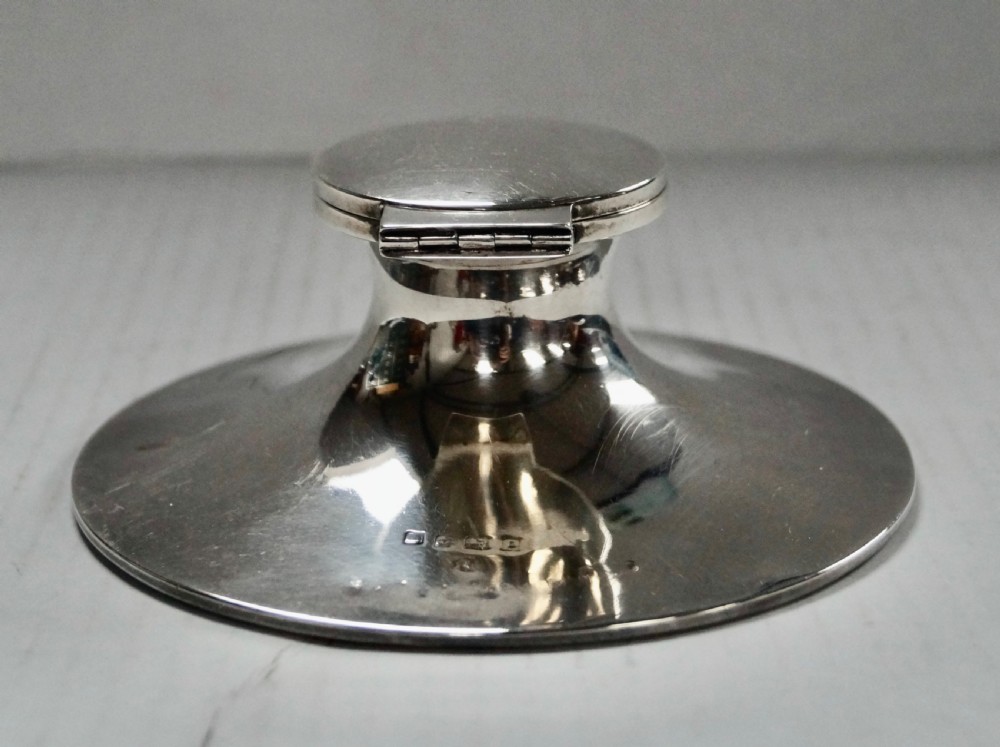 A solid sterling silver capstan inkwell with a circular flared base and an open hinged lid, displaying Birmingham hallmarks. View VII