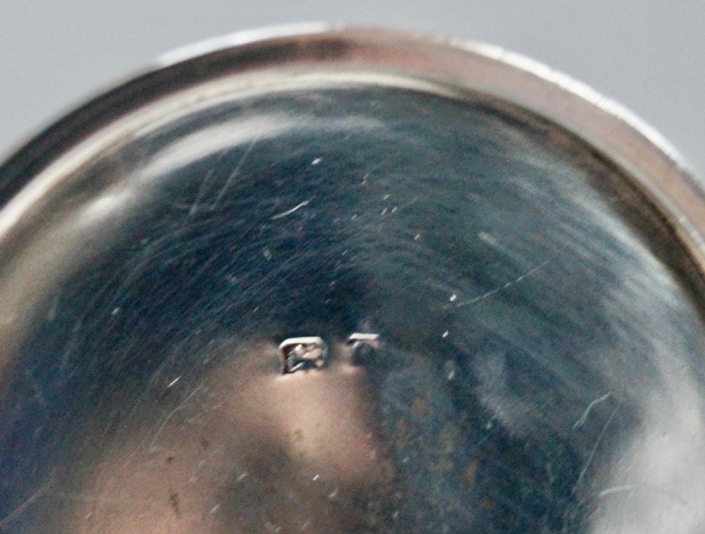 A solid sterling silver capstan inkwell with a circular flared base and an open hinged lid, displaying Birmingham hallmarks. View IX