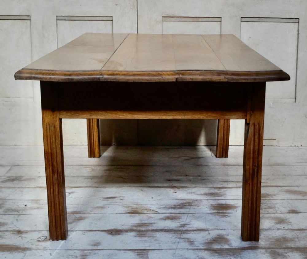 A low rectangular antique French chestnut occasional table with a wide planked top and simple straight legs. View VII