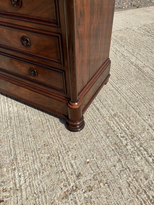 fig 2. A French rosewood commode with four wide drawers, turned wooden knobs, and a dark polished grain finish.