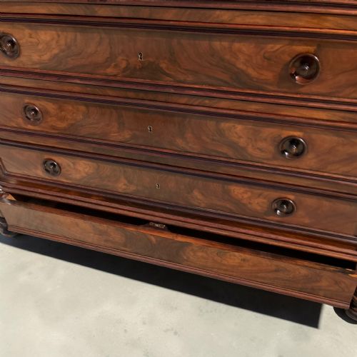 fig 3. A French rosewood commode with four wide drawers, turned wooden knobs, and a dark polished grain finish.