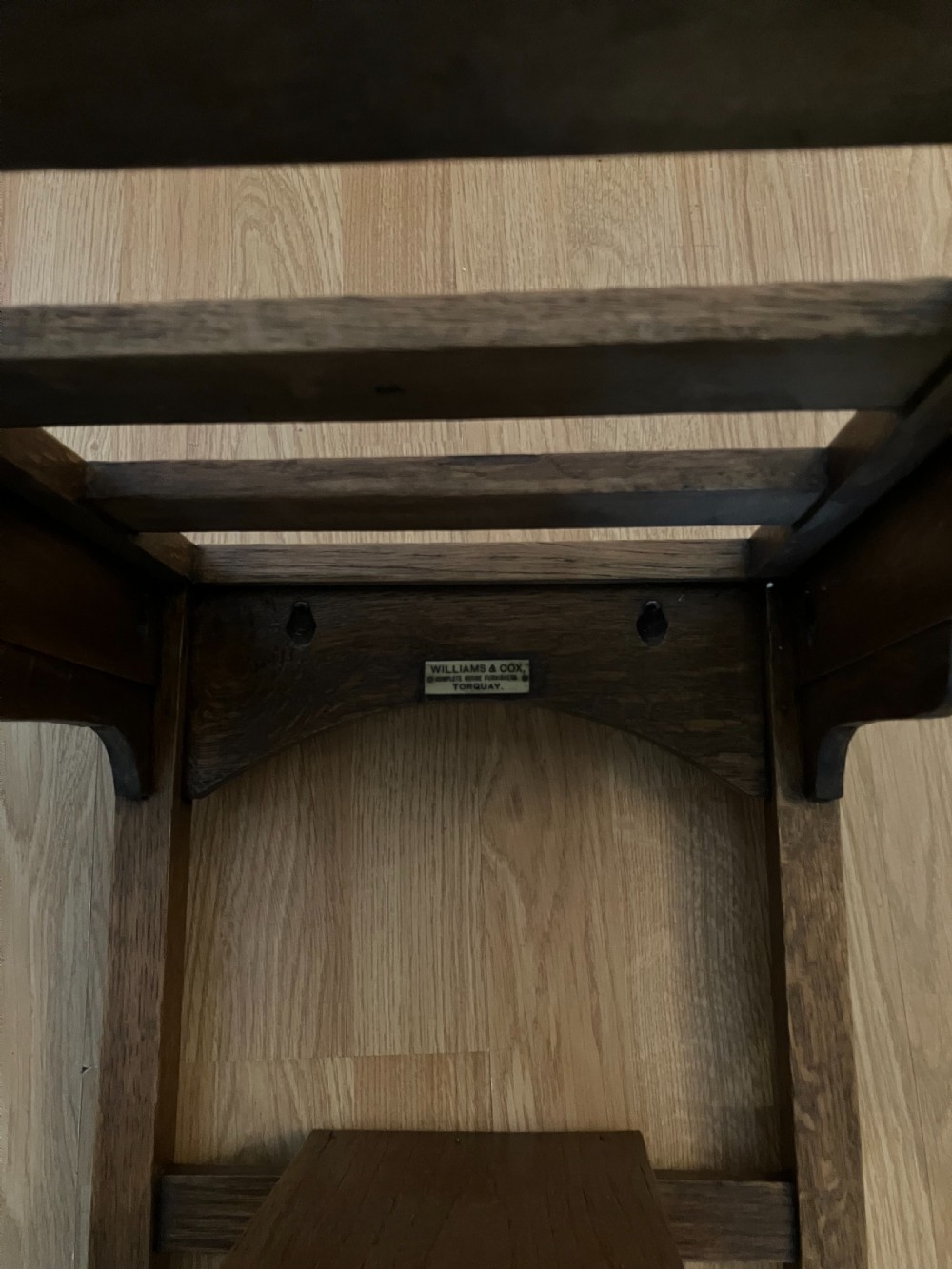 A dark oak luggage rack featuring a slatted top surface, lower shelf tier, rectangular frame, and square legs. View II