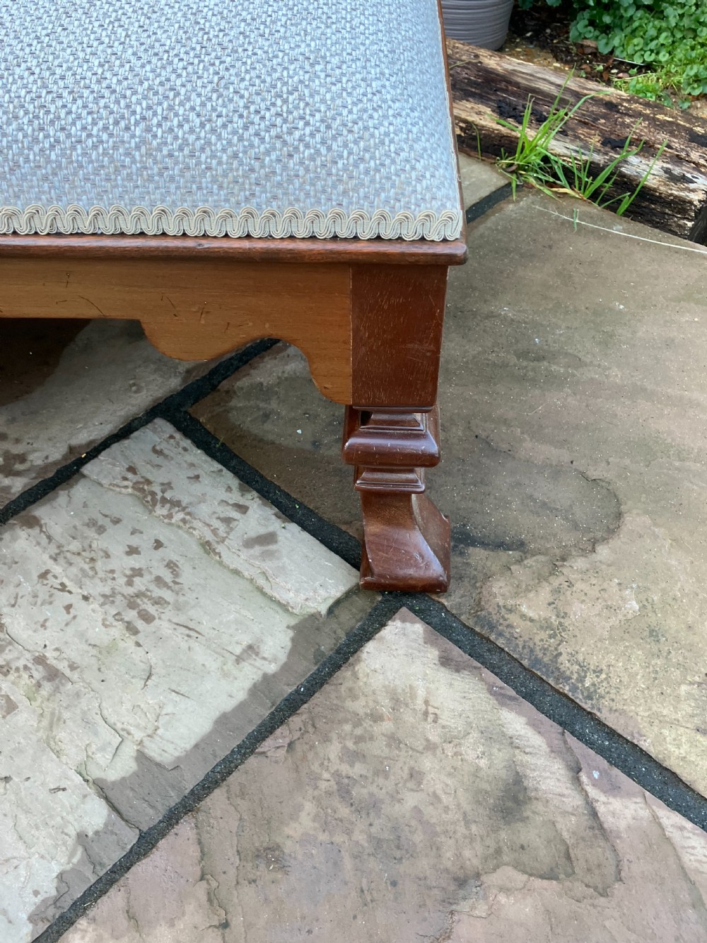 A low rectangular Victorian mahogany footstool upholstered in pale blue fabric with a shaped apron and turned legs. View V