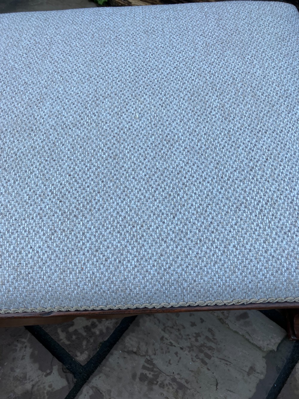 A low rectangular Victorian mahogany footstool upholstered in pale blue fabric with a shaped apron and turned legs. View VI