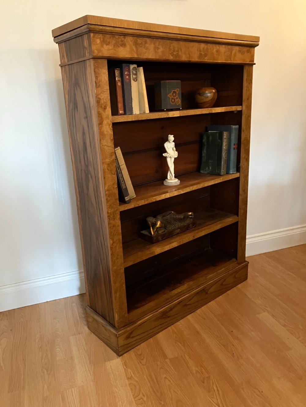 A Victorian pollard oak open bookcase featuring multiple fixed shelves, rich burl graining along the frame, and a wide plinth base. View II