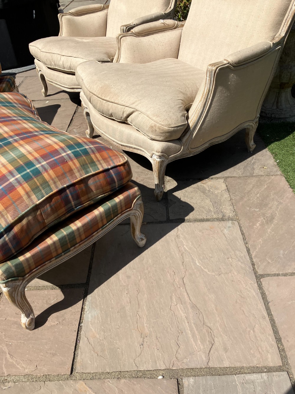 A pair of French Louis XV style bergere armchairs featuring neutral fabric upholstery, distressed white painted timber frames, and carved cabriole legs. View II
