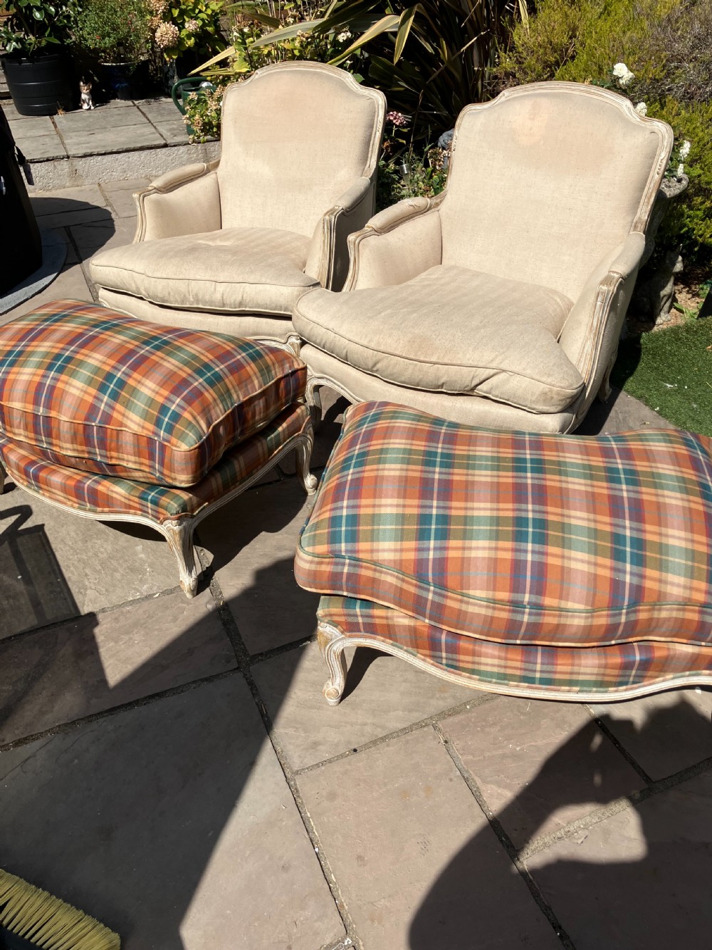 A pair of French Louis XV style bergere armchairs featuring neutral fabric upholstery, distressed white painted timber frames, and carved cabriole legs. View III