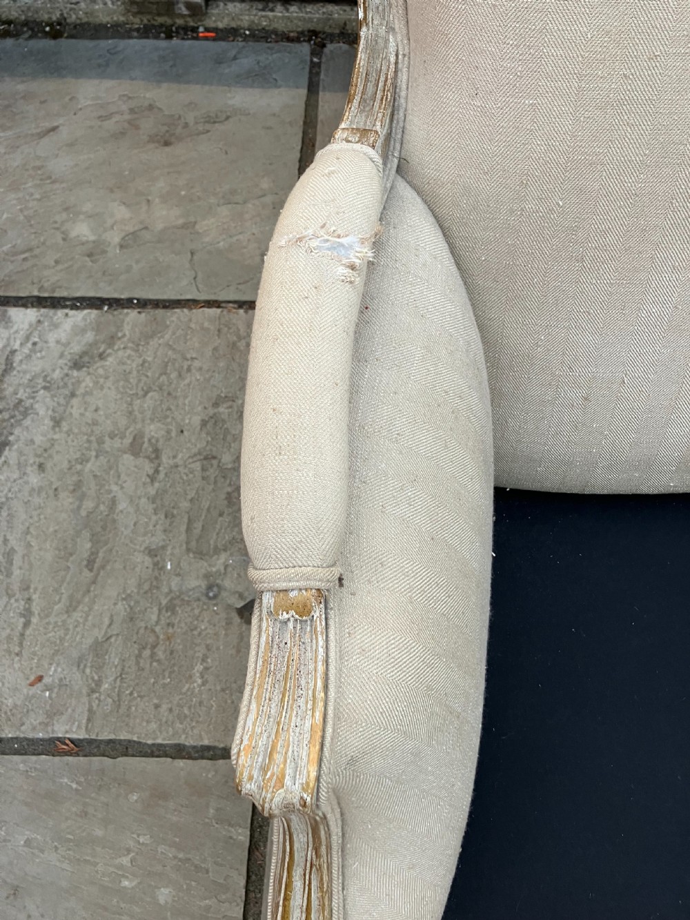 A pair of French Louis XV style bergere armchairs featuring neutral fabric upholstery, distressed white painted timber frames, and carved cabriole legs. View IV