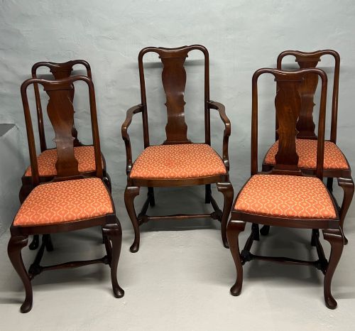 fig 1. A set of five dark mahogany Queen Anne style dining chairs featuring vase-shaped splat backs, cabriole legs, and patterned terracotta fabric seats.