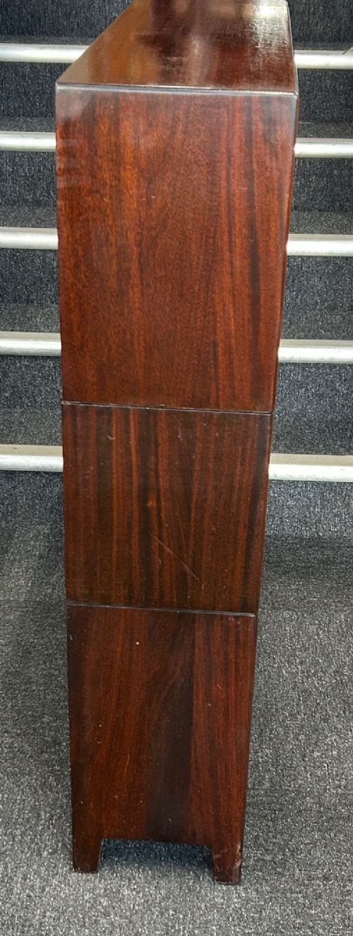 A three-tier mahogany barrister bookcase featuring glazed front doors and small circular brass knobs. View III