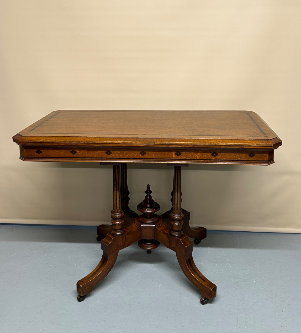 Oak games table in the style of Charles Bevan 