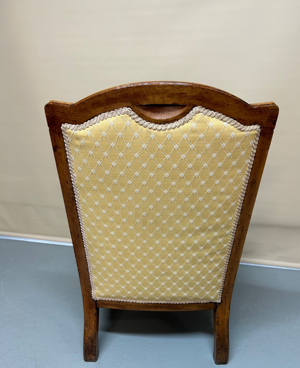 A pair of Victorian pollard oak armchairs upholstered in yellow patterned fabric featuring reeded turned legs and brass castors. View VIII