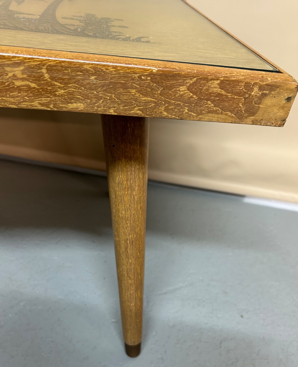 A light wood living room set featuring a low glass-top coffee table, standard lamp, table lamp base, and magazine rack, all decorated with pyrographic tropical scene carvings. View III