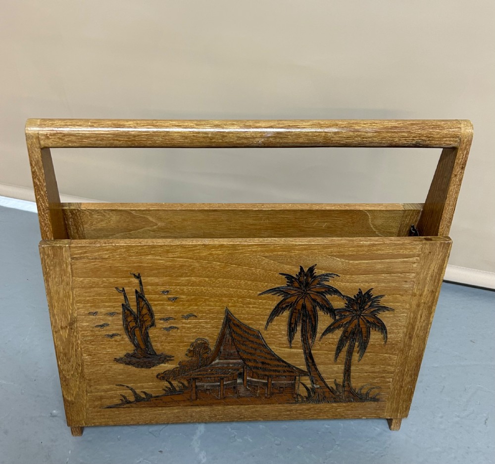 A light wood living room set featuring a low glass-top coffee table, standard lamp, table lamp base, and magazine rack, all decorated with pyrographic tropical scene carvings. View V