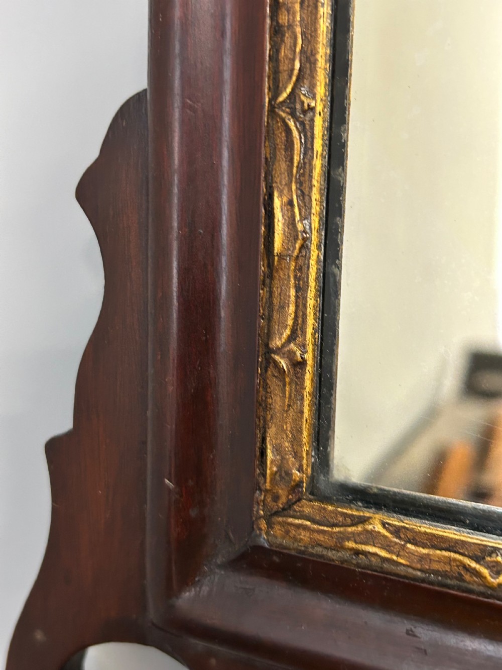 A rectangular Georgian style mahogany wall mirror featuring a scroll-cut fretwork frame topped with a gilded bird crest. View III