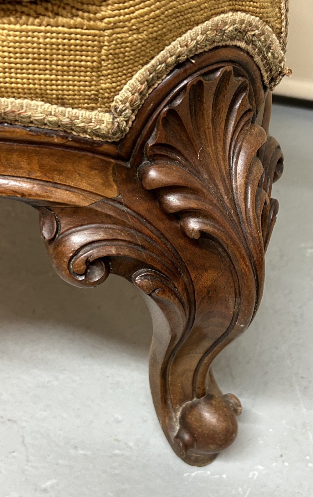 A Victorian carved walnut nursing chair with floral needlepoint tapestry upholstery and cabriole legs. View VII
