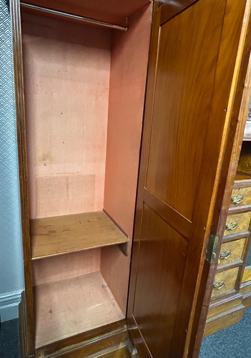 A large Victorian pollard oak breakout wardrobe featuring twin mirrored doors flanking a central carved cupboard above an open niche and five drawers with brass handles. View VII