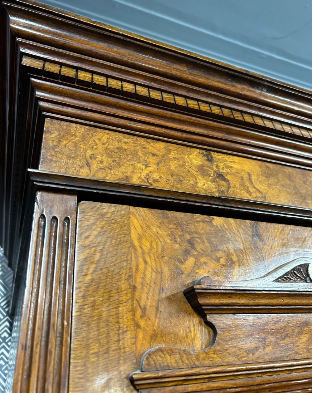A large Victorian pollard oak breakout wardrobe featuring twin mirrored doors flanking a central carved cupboard above an open niche and five drawers with brass handles. View X