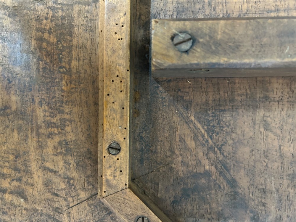 An octagonal wooden side table with high-relief carvings of dragons across the top surface and pierced base. View X