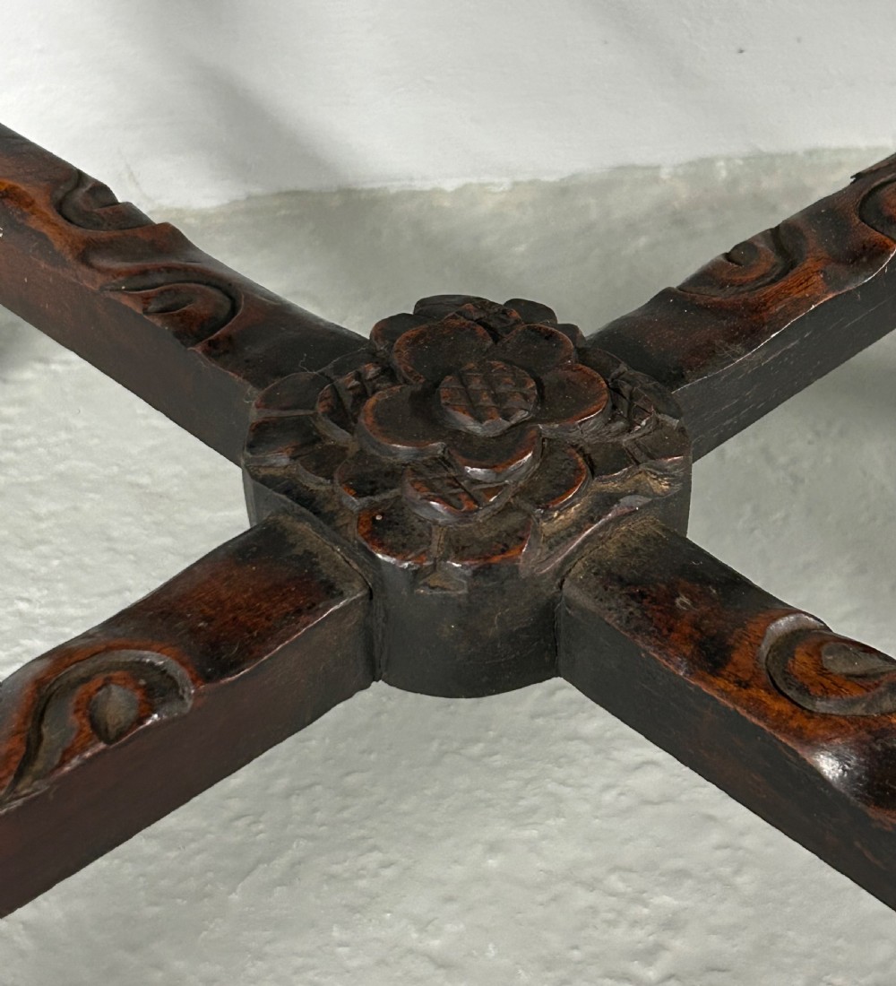 A square carved dark hardwood side table featuring an inset variegated marble top, pierced floral apron, and curved legs with an X-stretcher. View III