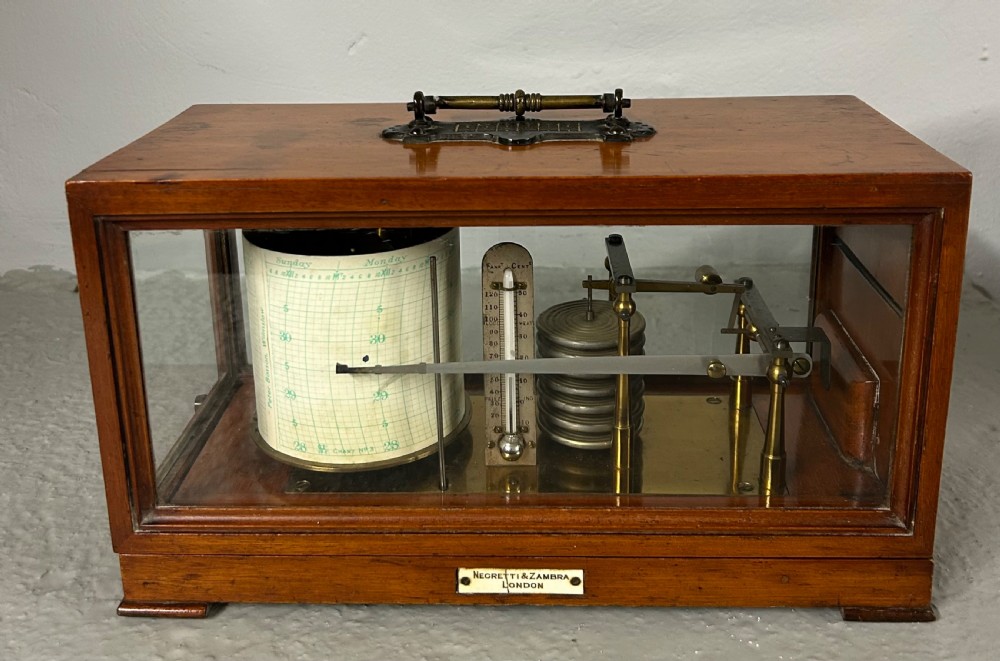 An antique oak and glass barograph featuring a revolving chart drum, internal brass mechanism, thermometer scale, and a brass carrying handle on top. View II