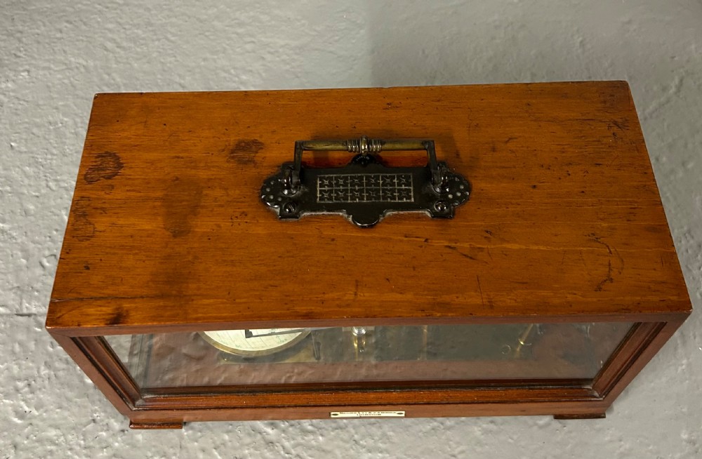 An antique oak and glass barograph featuring a revolving chart drum, internal brass mechanism, thermometer scale, and a brass carrying handle on top. View X