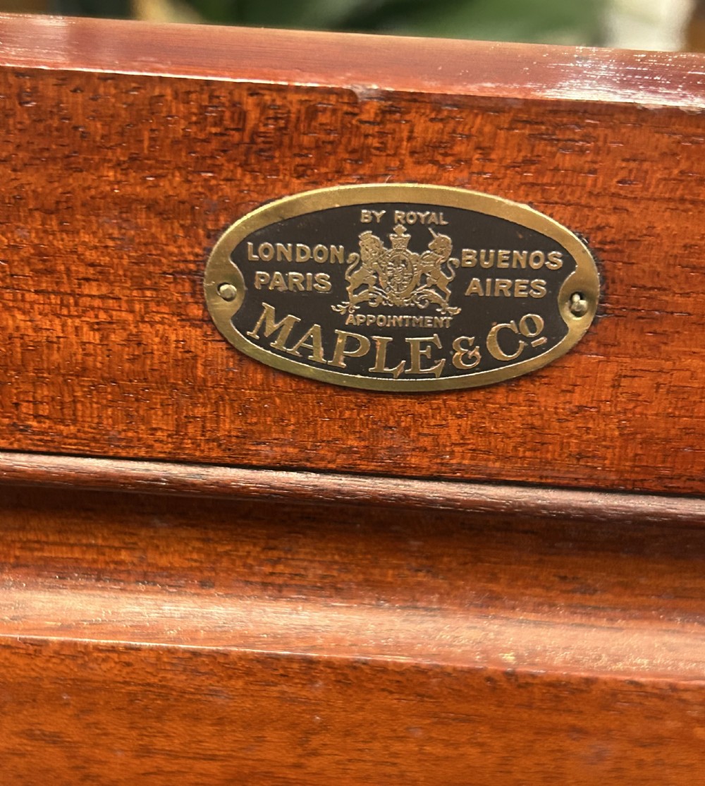 A tall mahogany gentlemans chest featuring five left-hand drawers beside a panelled cupboard door, over a wide base drawer with brass handles. View IX