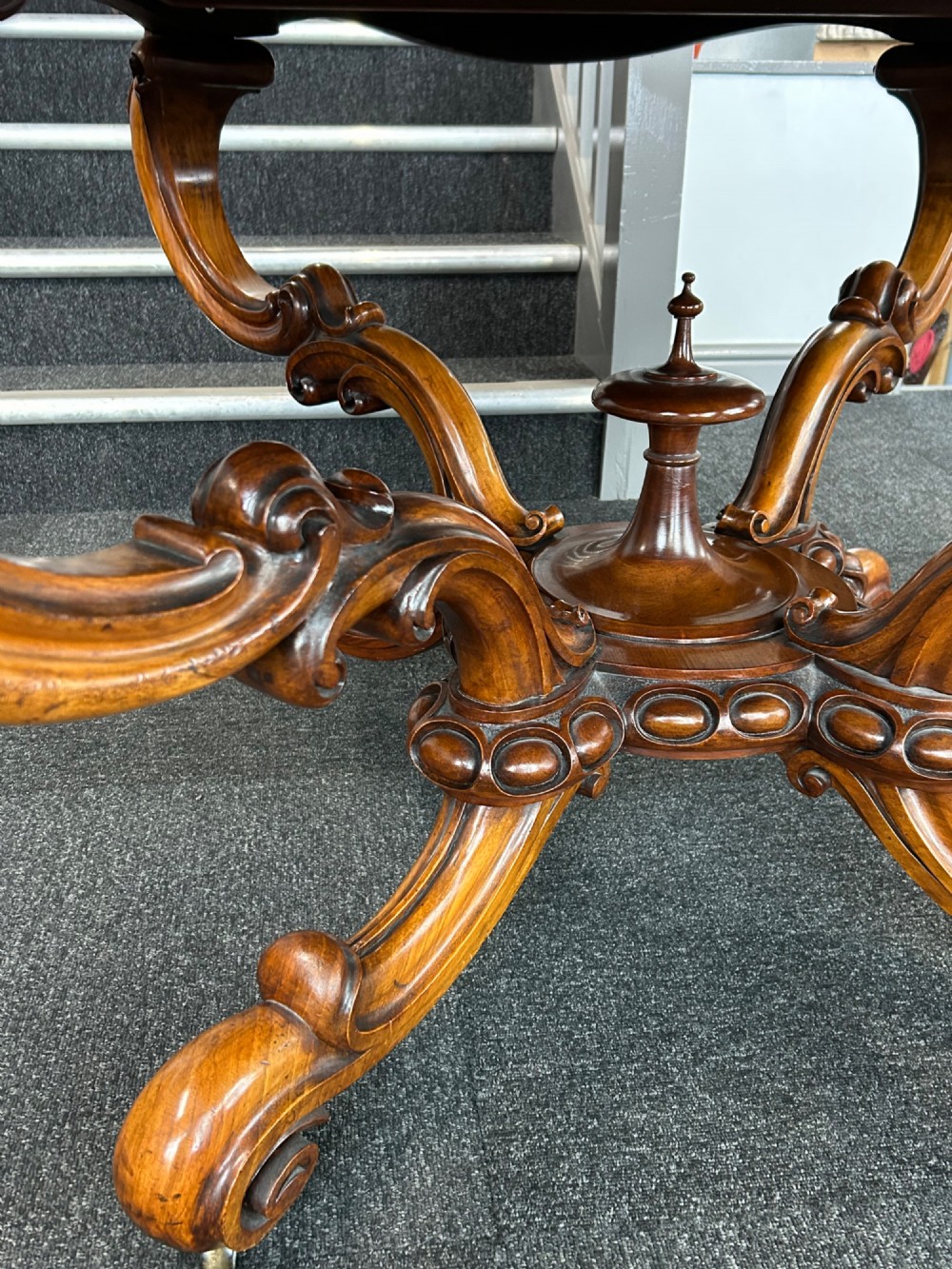 A Victorian burr walnut centre table featuring a serpentine shaped top with marquetry inlay and carved cabriole legs. View VIII