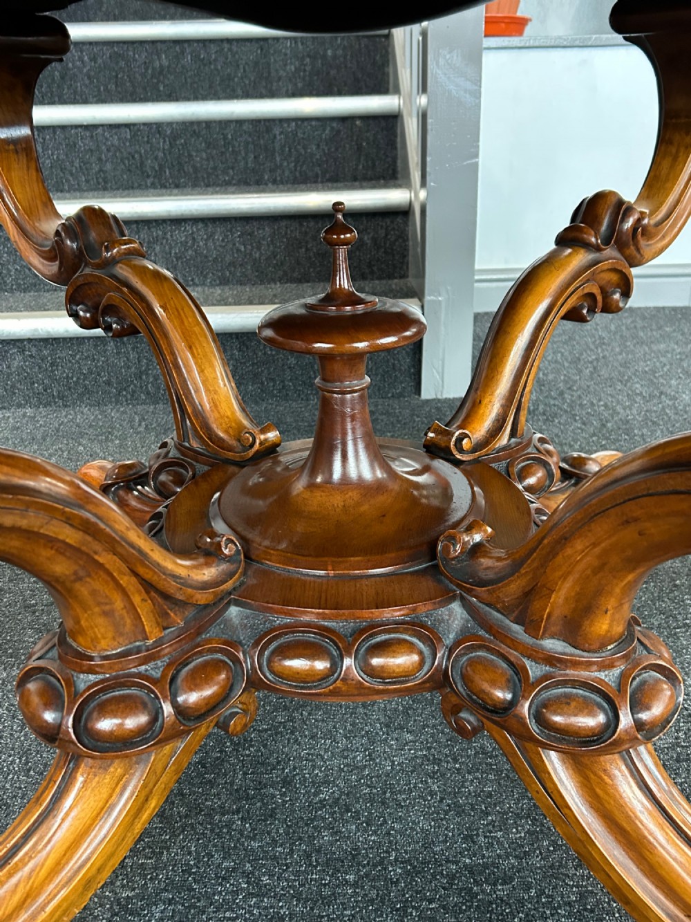 A Victorian burr walnut centre table featuring a serpentine shaped top with marquetry inlay and carved cabriole legs. View IX