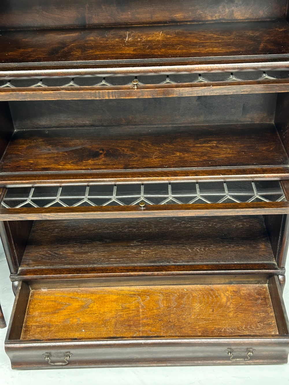 A pair of dark oak Globe Wernicke sectional bookcases featuring four leaded glass door compartments and a base drawer each. View VII