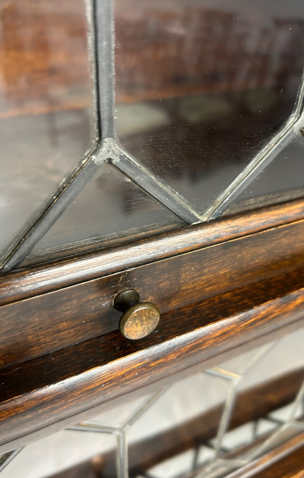 A pair of dark oak Globe Wernicke sectional bookcases featuring four leaded glass door compartments and a base drawer each. View XII