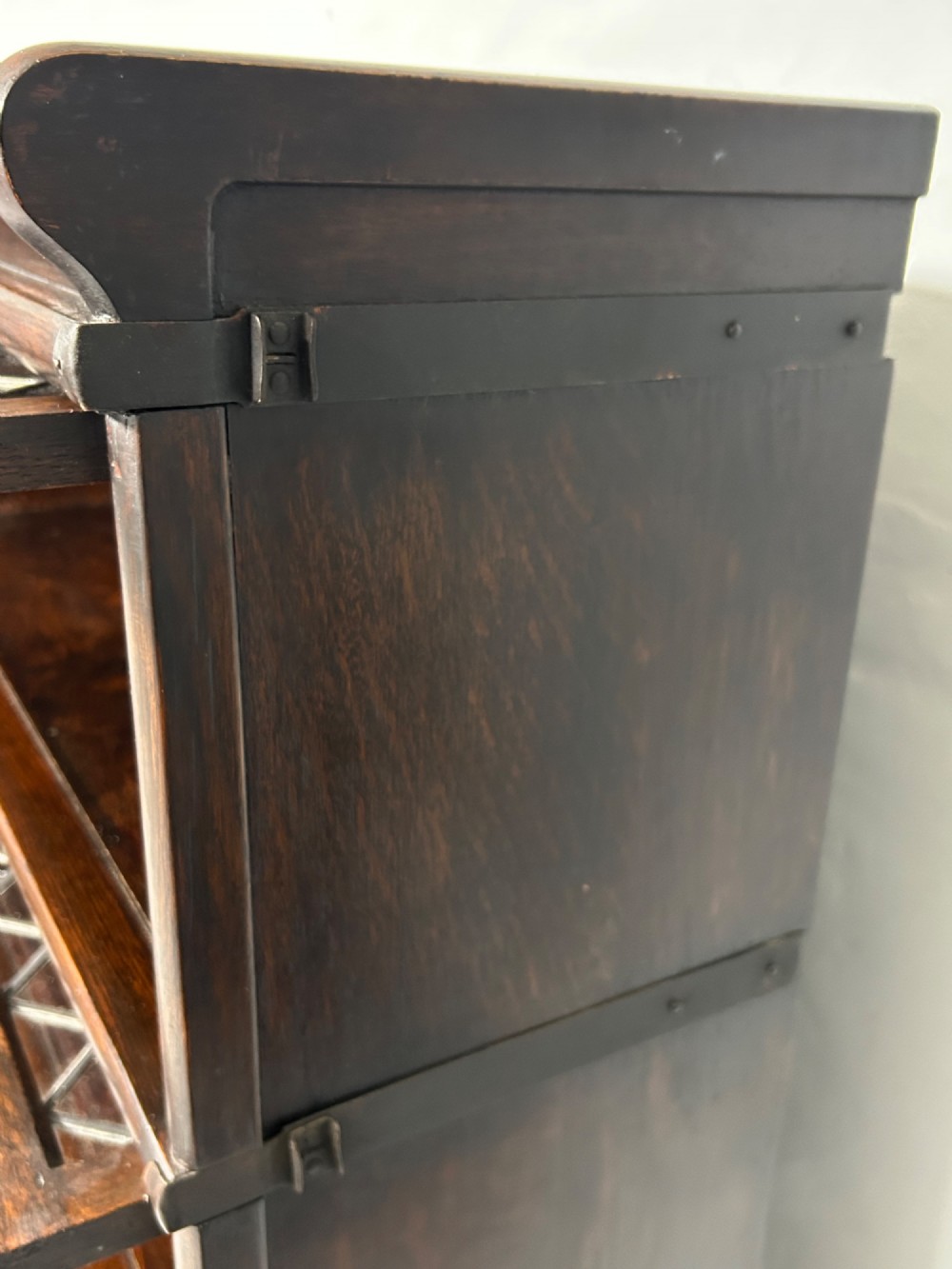 A pair of dark oak Globe Wernicke sectional bookcases featuring four leaded glass door compartments and a base drawer each. View XIII