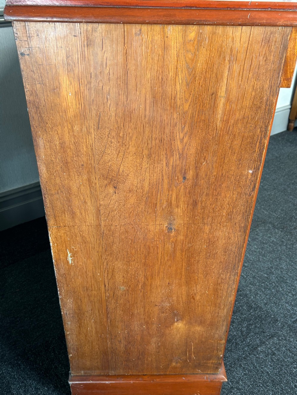 A Victorian mahogany and oak chest of drawers featuring two short drawers over three long drawers with turned wooden knobs and roundel details. View VII