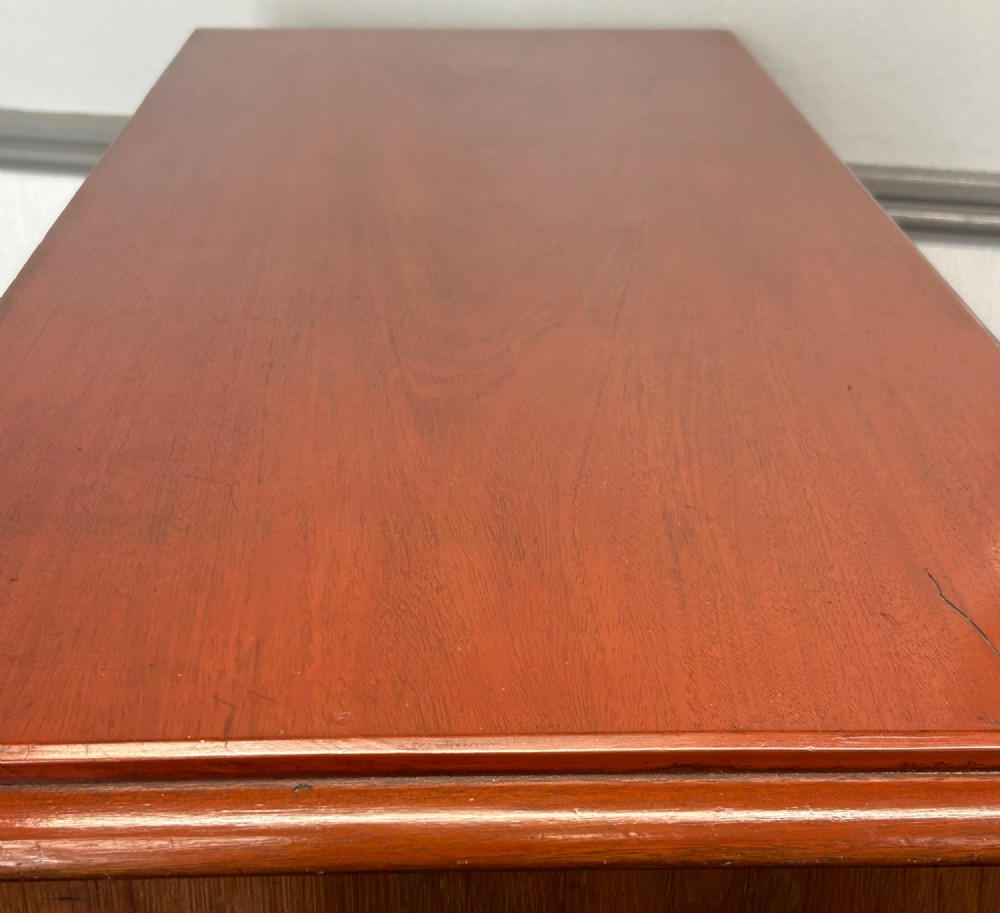 A Victorian mahogany and oak chest of drawers featuring two short drawers over three long drawers with turned wooden knobs and roundel details. View VIII