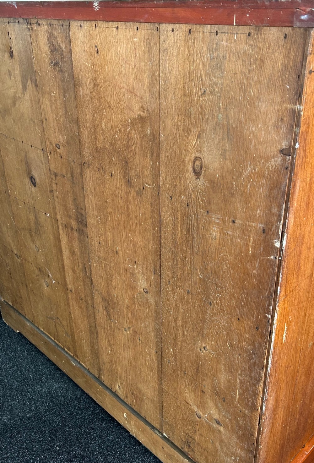 A Victorian mahogany and oak chest of drawers featuring two short drawers over three long drawers with turned wooden knobs and roundel details. View XI