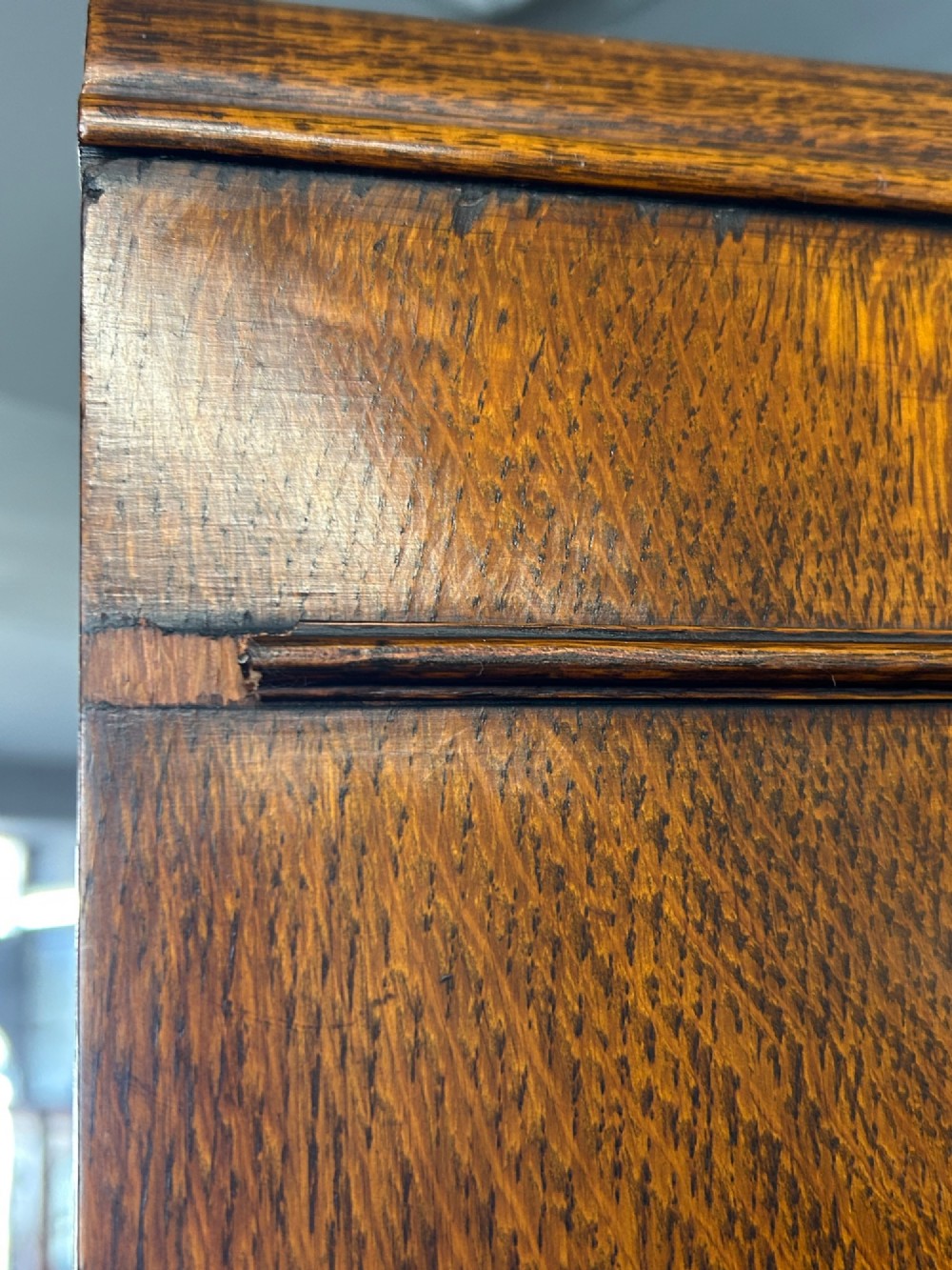 A tall 1920s solid oak hall robe featuring a single door with carved arcading and linenfold panelling, canted sides, and turned feet. View IX