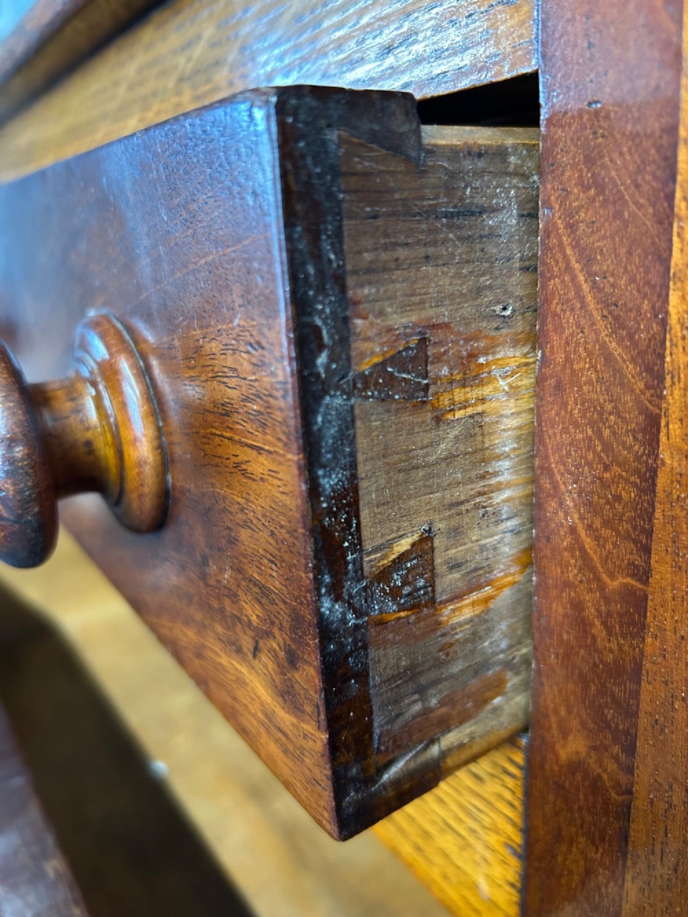 An antique oak Welsh dresser featuring an upper open plate rack with shelves and a lower breakfront base with central drawers flanked by cupboards. View VIII