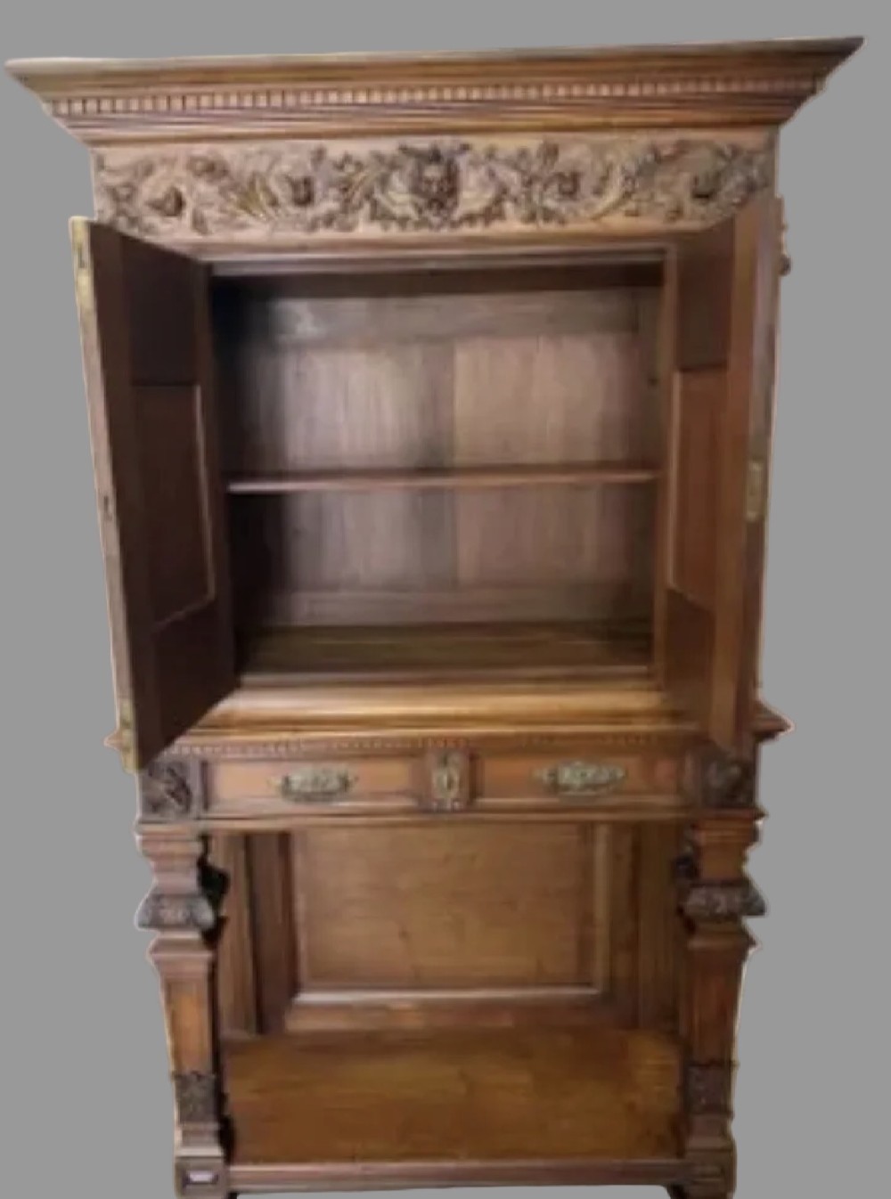 A 19th-century Renaissance Revival carved wood cabinet-on-stand with intricate relief carvings, twin doors, upper drawers, and an open lower shelf. View III