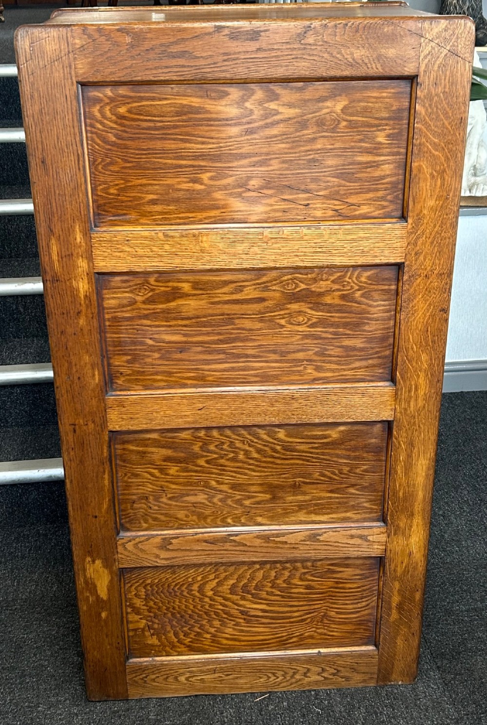 A vertical four-drawer golden oak filing cabinet featuring brass label holders and metal pull handles. View II