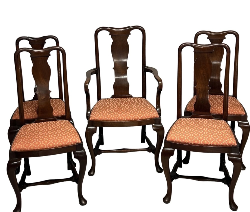 A set of five dark mahogany Queen Anne style dining chairs featuring vase-shaped splat backs, cabriole legs, and patterned terracotta fabric seats.
