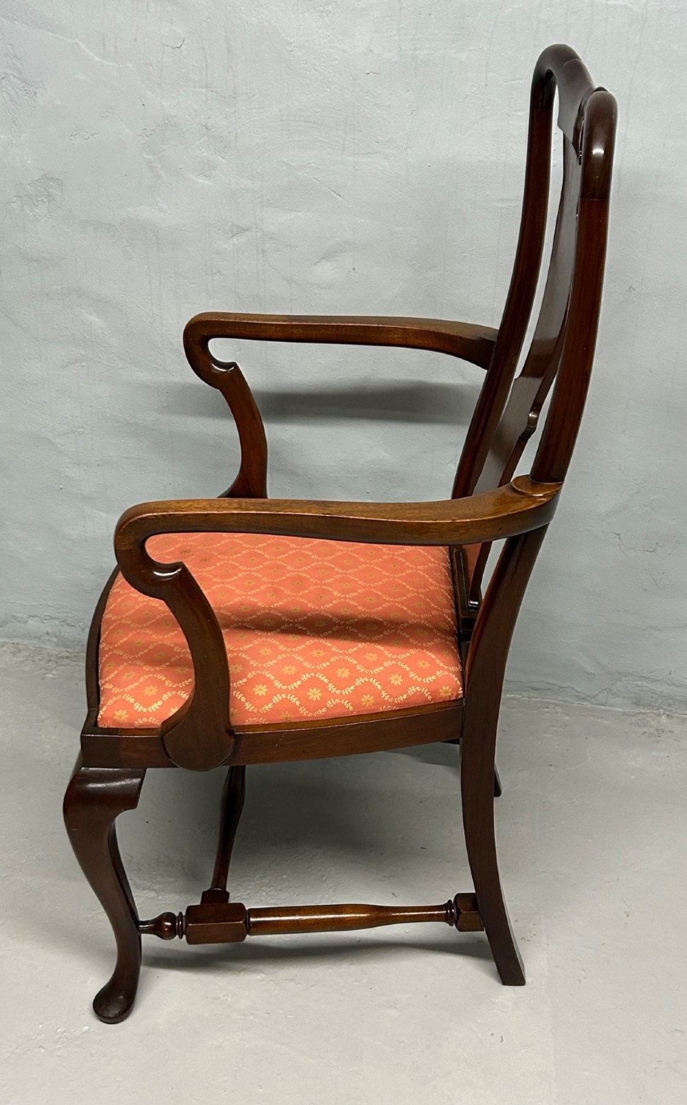 A set of five dark mahogany Queen Anne style dining chairs featuring vase-shaped splat backs, cabriole legs, and patterned terracotta fabric seats. View IV