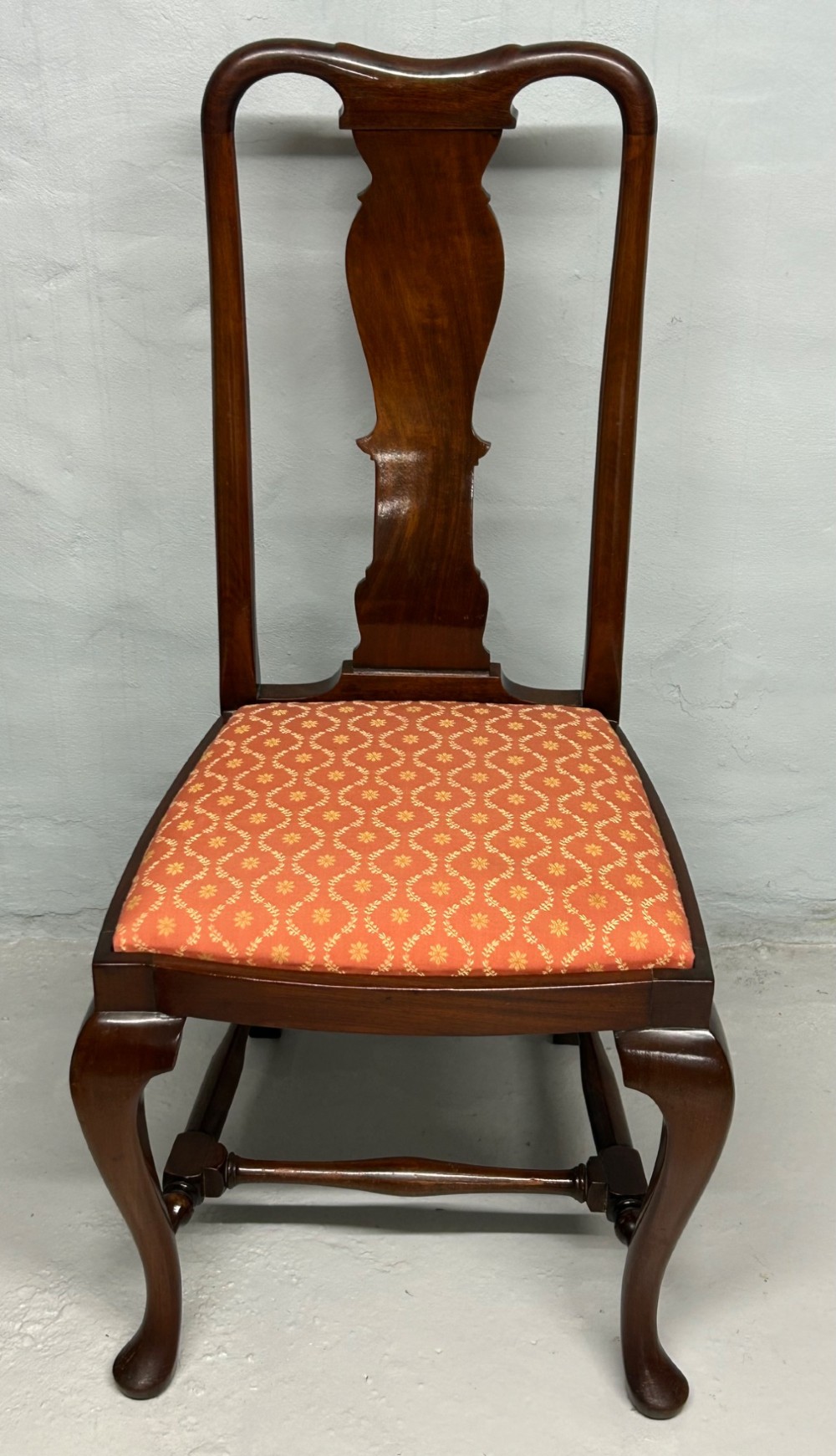 A set of five dark mahogany Queen Anne style dining chairs featuring vase-shaped splat backs, cabriole legs, and patterned terracotta fabric seats. View V