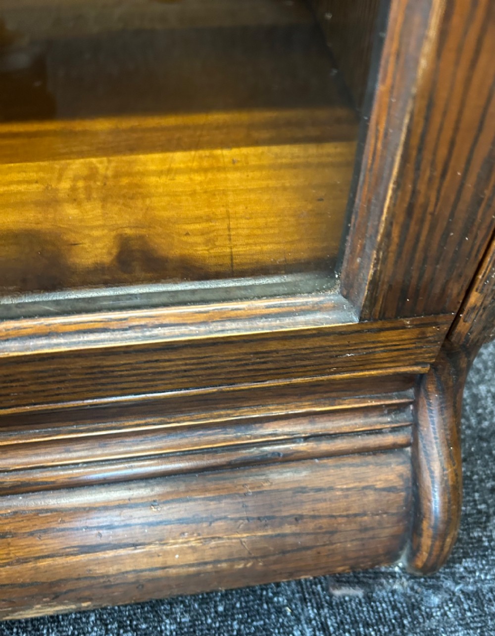 A five-tier oak barrister bookcase with glazed up-and-over doors and small brass knobs. View VI