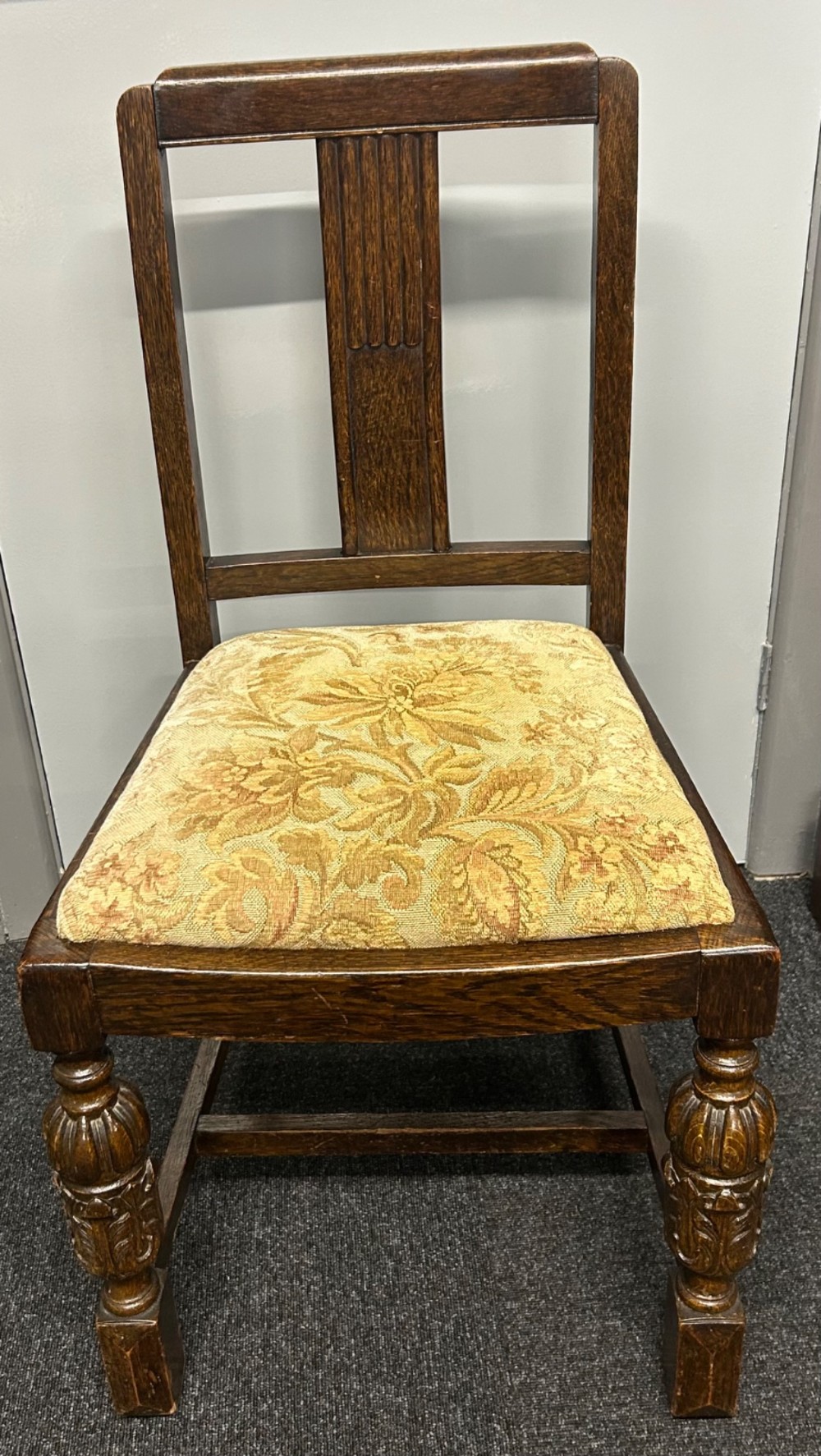 An Art Deco dark oak dining table featuring carved legs paired with four matching chairs with patterned upholstered seats. View XI