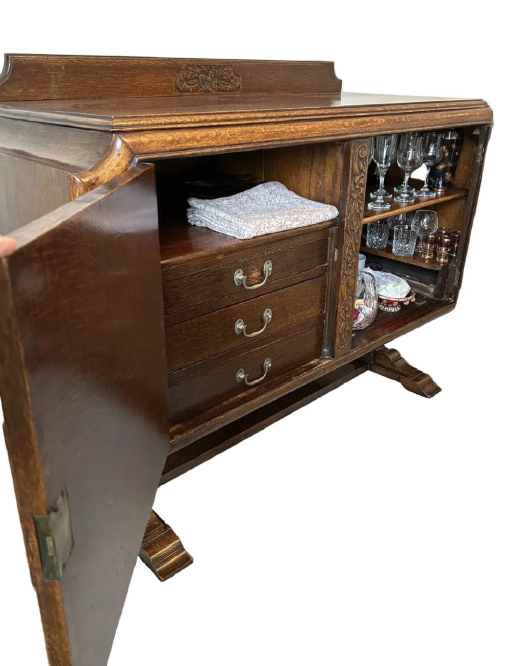An Art Deco dark oak sideboard featuring diamond-pattern veneered double doors, carved floral borders, wooden handles, and a low upstand gallery. View III