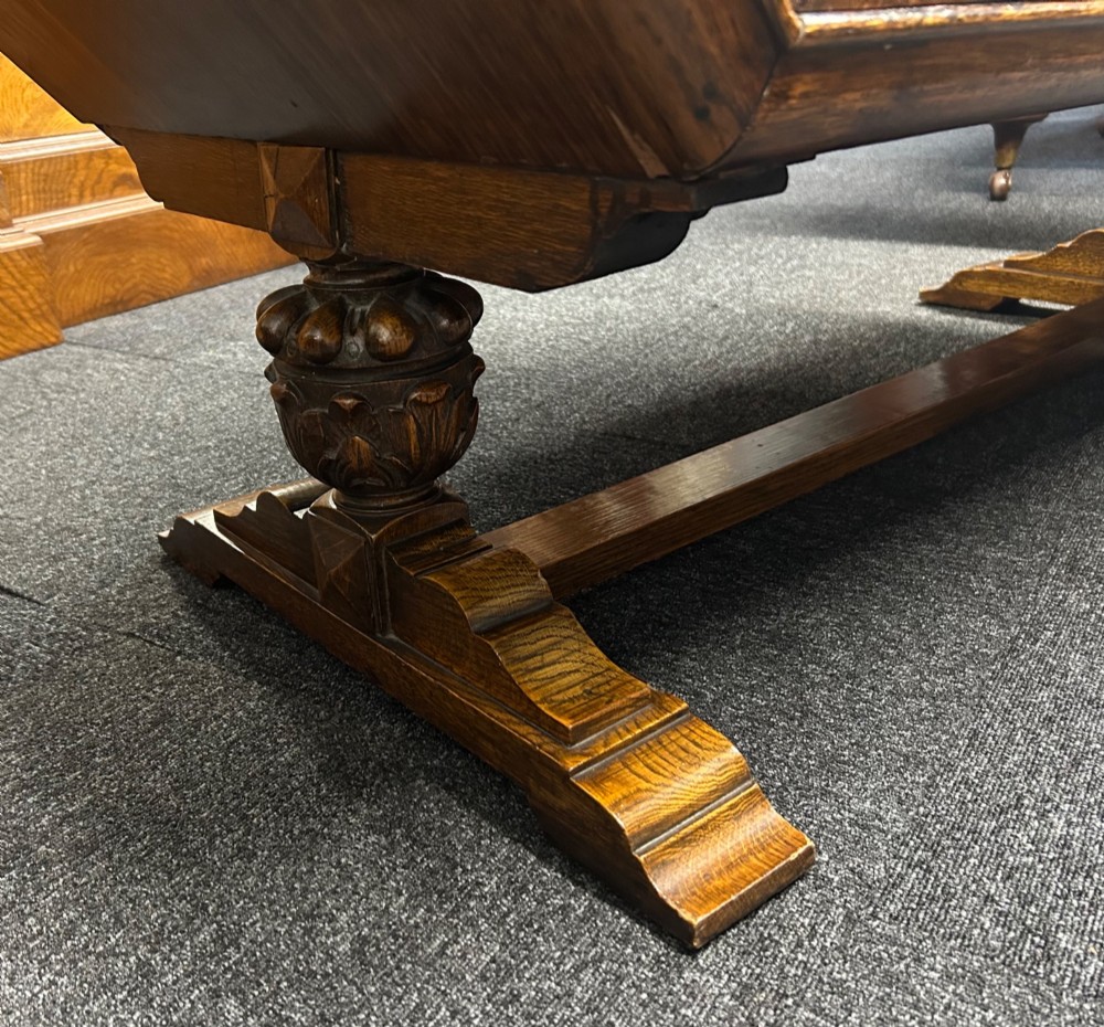 An Art Deco dark oak sideboard featuring diamond-pattern veneered double doors, carved floral borders, wooden handles, and a low upstand gallery. View IV