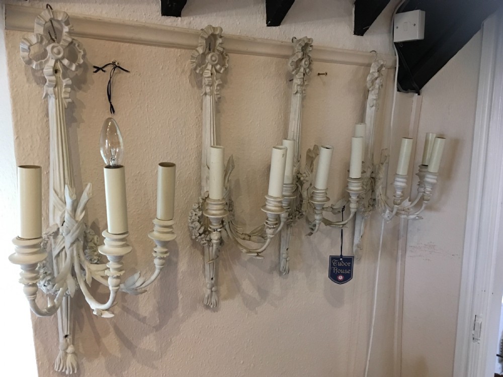 Set of four three branch antique wall lights 